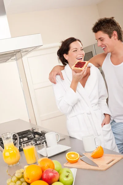 若い男性と女性の近代的なキッチンで朝食のトーストを食べる — ストック写真