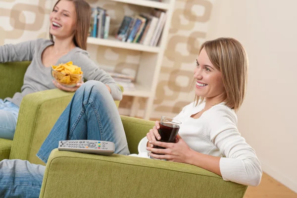Students - Two smiling female teenager watching television toget — Stock Photo, Image