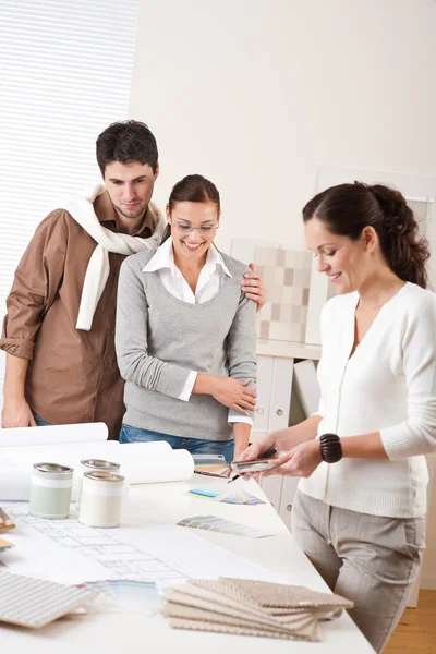 Female interior designer with two clients at office — Stock Photo, Image