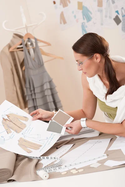 Female fashion designer working with sketches — Stock Photo, Image