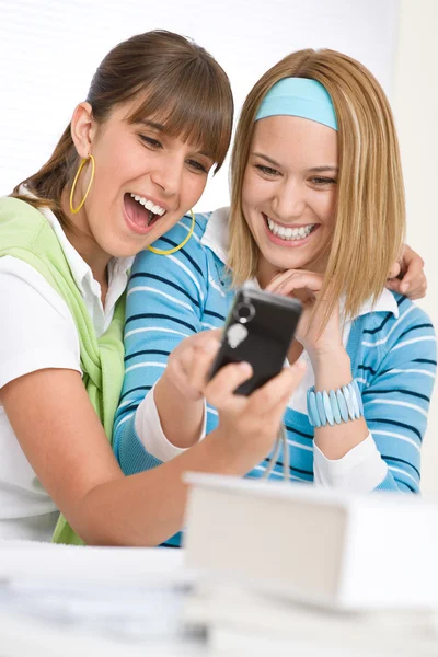 Two young cheerful woman with camera — Stock Photo, Image