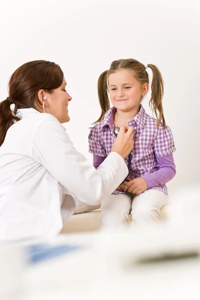 Female doctor examining child with stethoscope Stock Picture