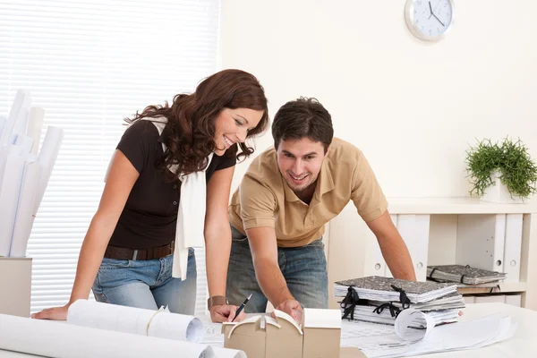 Young man and woman working at architect office Stock Photo