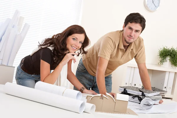Young man and woman working at architect office Royalty Free Stock Images