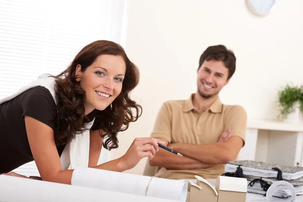 Smiling man and woman with architectural model Stock Image