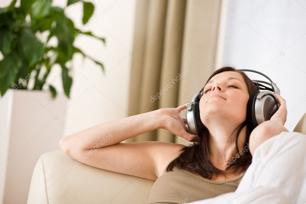 Smiling woman with headphones listen to music
