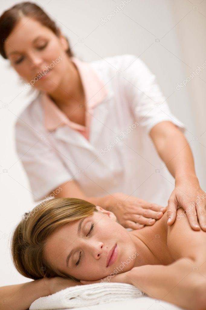 Luxury care - woman getting back massage at spa center