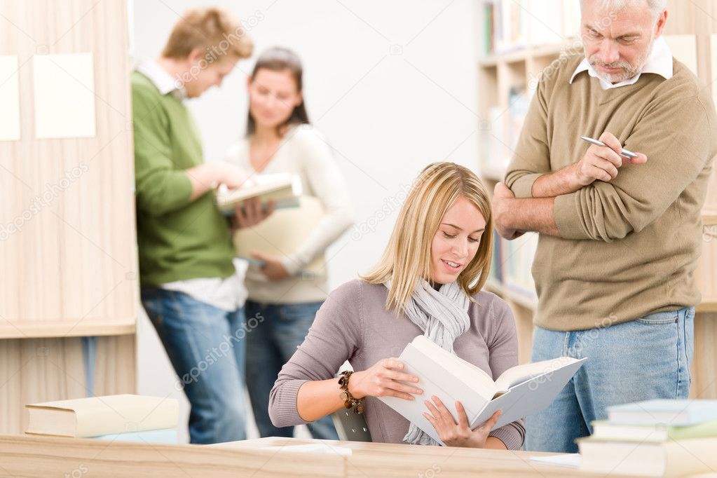 High school library - female student with mature professor read book