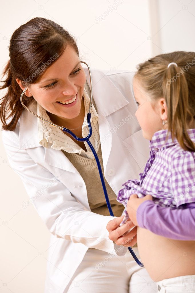 Female doctor examining child with stethoscope at medical office