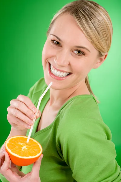 Healthy lifestyle - woman drink juice from orange with straw — Stock Photo, Image