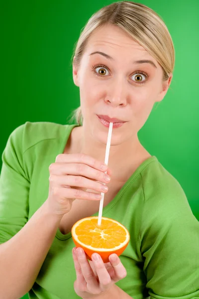 Healthy lifestyle - woman drink juice from orange — Stock Photo, Image