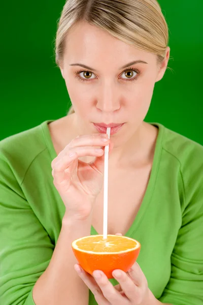 Healthy lifestyle - woman drink juice from orange with straw — Stock Photo, Image