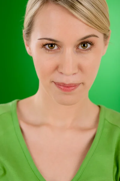 Portrait of young woman on green background — Stock Photo, Image
