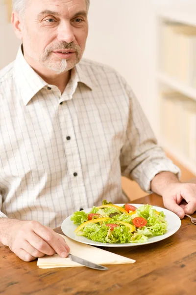 stock image Senior mature man eat vegetable salad