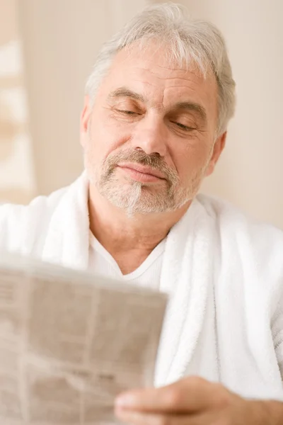 Senior mature man thoughtful read newspaper — Stock Photo, Image