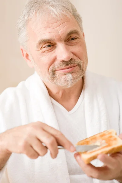 Senior mature man having breakfast toast — Stock Photo, Image