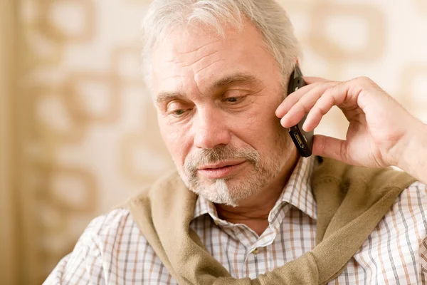 Thoughtful senior mature man with mobile phone — Stock Photo, Image