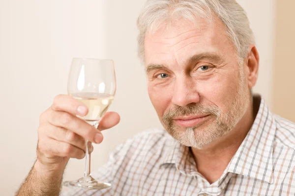 Senior mature man with glass of white wine — Stock Photo, Image