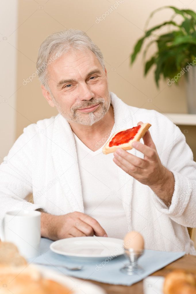 Senior mature man - breakfast at home