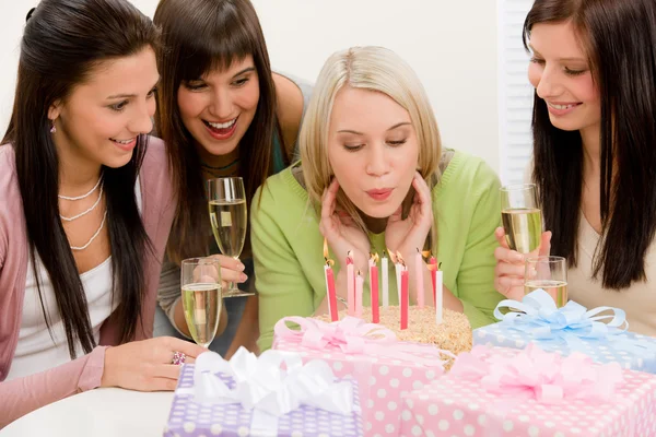 Birthday party - woman blowing candle on cake — Stock Photo, Image