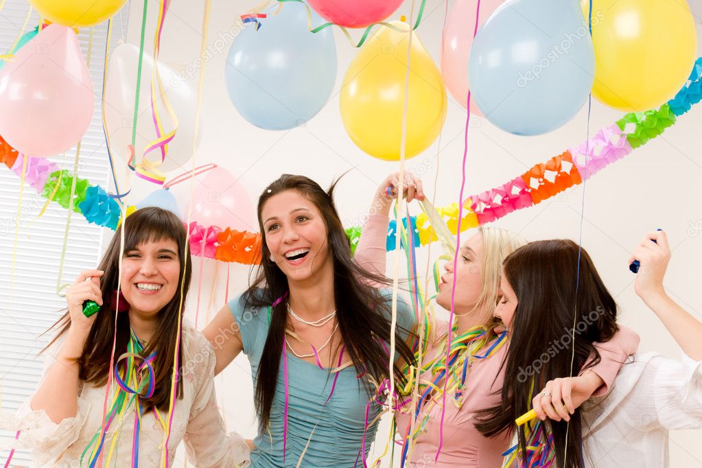 Birthday party celebration - four woman with confetti have fun