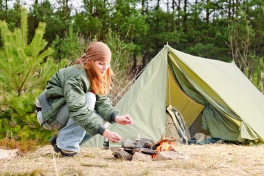 Camping woman tent cook food fire nature clipart