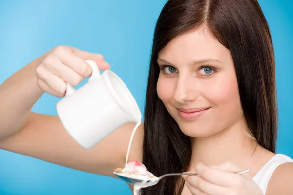 Healthy lifestyle - young woman pour milk cereal — Stock Photo, Image