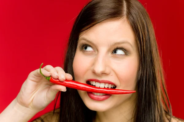 Chili pepper - portrait young woman bite red spicy — Stock Photo, Image