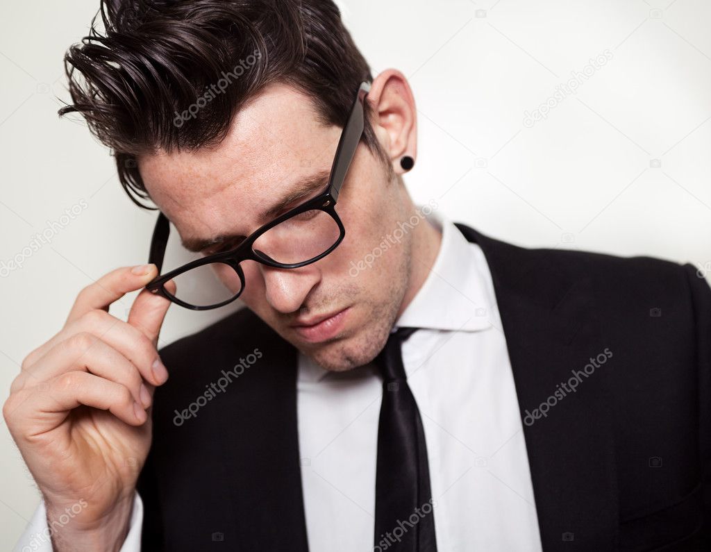 Young Businessman holding black glasses