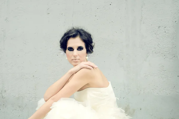 Beautiful girl with a mystic look on a grey background — Stock Photo, Image