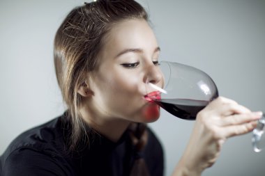 Portrait of beautiful woman, holding glass of red wine clipart