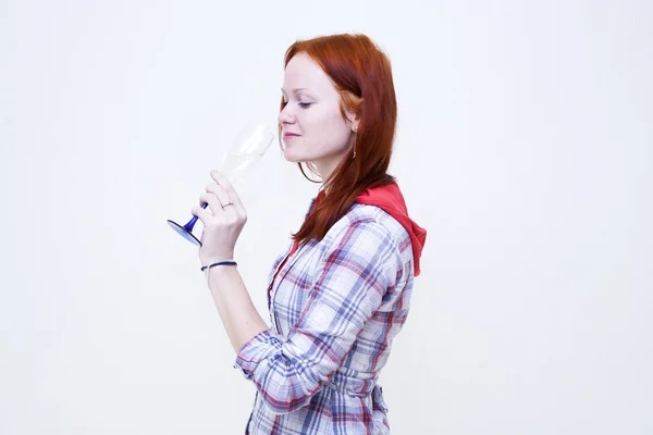 Redhead young woman is drinking from glass — Stock Photo, Image