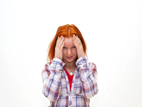 Redhead young woman holding her hand to the head — Stock Photo, Image