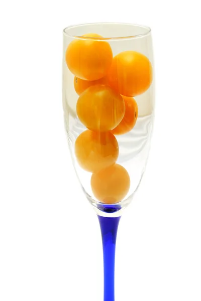 Glass is filled by yellow tomatoes — Stock Photo, Image