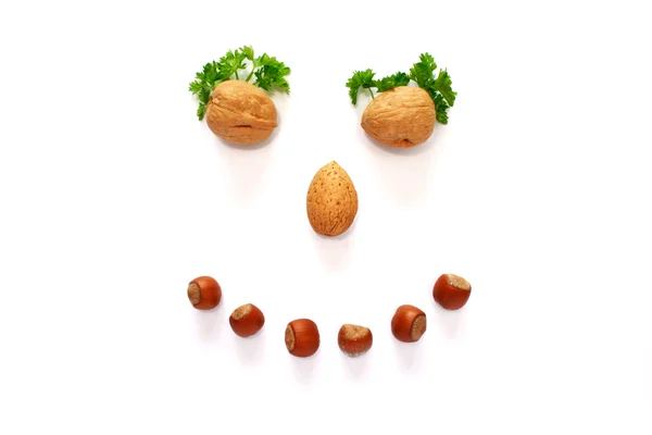 Smiling face made whith help of nuts — Stock Photo, Image