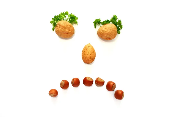 Sad face made whith help of nuts — Stock Photo, Image