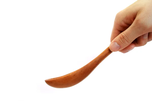Wooden spoon for cooking in the hand — Stock Photo, Image