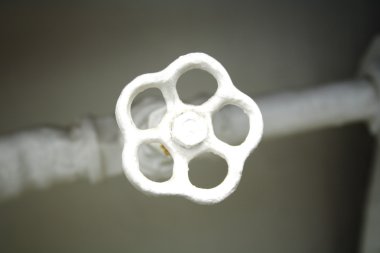 Old white radiator valve close up clipart