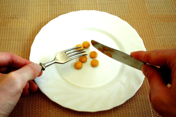 Pills on the white plate — Stock Photo, Image