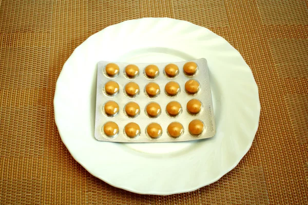 Pills on the white plate — Stock Photo, Image