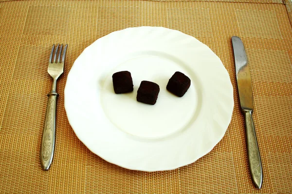 Black truffles on a white plate — Stock Photo, Image