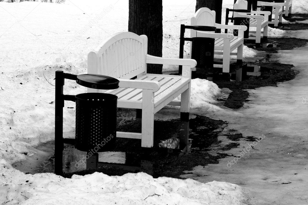 White bench in the park in winter time