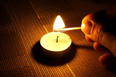 Candle ignition with match clipart