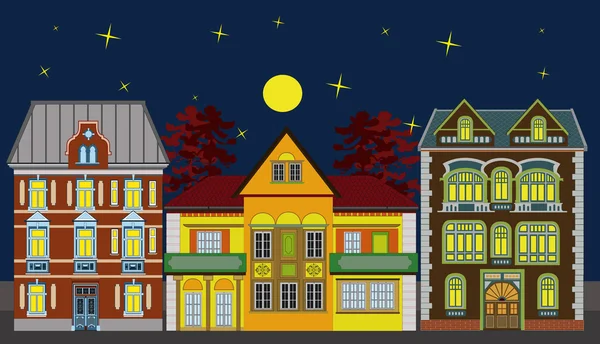 Drie residentiële huizen bij nacht — Stockfoto