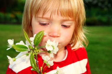 Child with white flowers clipart