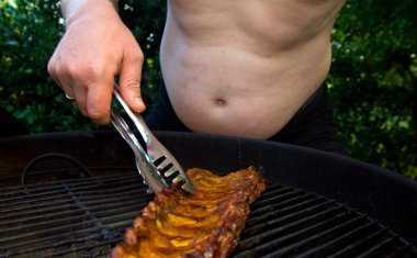 Fat man with big belly cooking rack of ribs on barbecue. unhealthy lifestyle and overweight body clipart