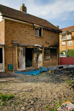 House ruin after fire. burned down property in urban area clipart