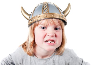 Angry child with viking helmet. boy isolated on white with expression of aggression. blond kid dressed up clipart