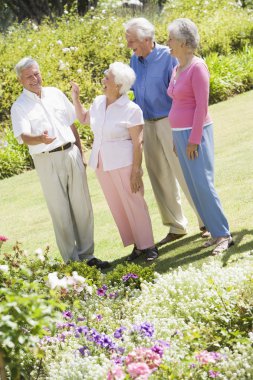 Group of senior friends in garden clipart