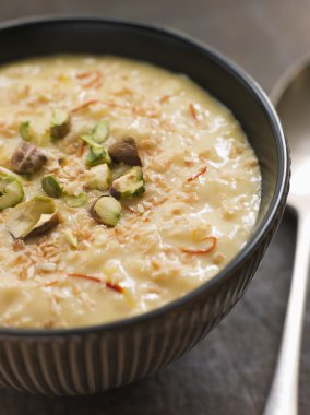 Bowl of Saffron Pistachio and Coconut Rice Pudding clipart